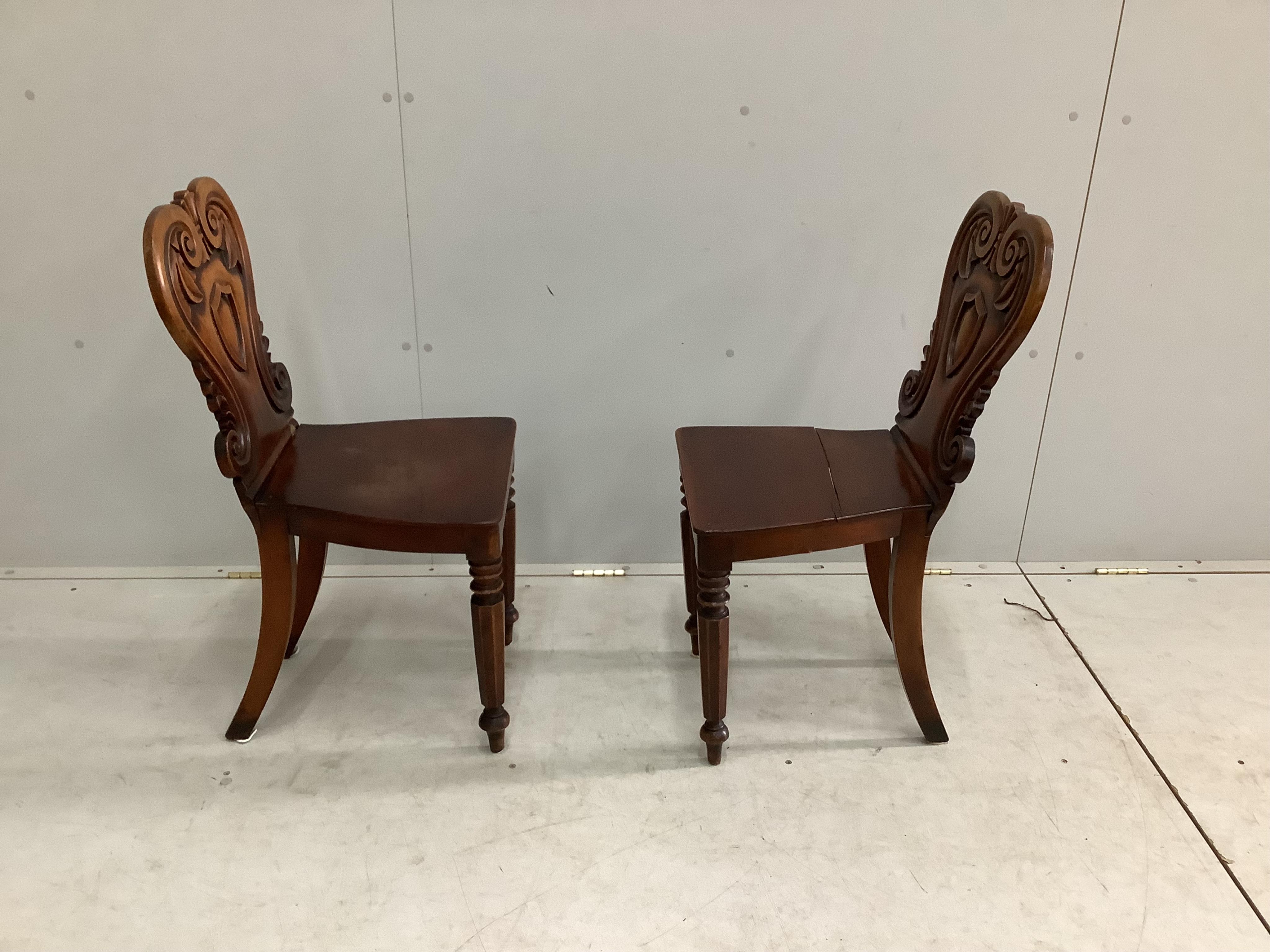 A pair of Victorian mahogany hall chairs, width 37cm, height 84cm. Condition - fair